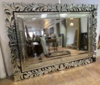 An impressive contemporary Venetian-style wall mirror, with heavily decorated exterior frame of