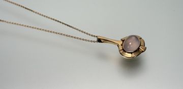 A Boodles 18ct rose gold pendant of lotus styleized design set oval rose quartz cabochon with