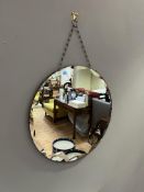 An Art Deco round mirror with scalloped bevelled edge and mounting chain (d. 50.5cm)