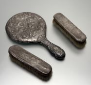 An Edwardian Chester silver-backed hand mirror with chased winged cherub back and handle: l. x 28.