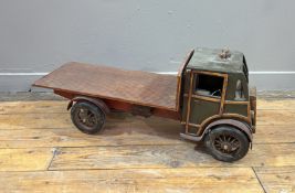 A vintage wooden polychrome and gilt painted wagon/ flat bed truck with working wheels and hinged