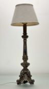 A tasteful wooden table lamp, in silver distress paint raised on three scroll feet with mirror