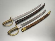 Two 19th century French briquet sabres, with curved single-edged blades and moulded brass hilts, the