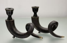 A pair of parcel-gilt patinated metal horn-form candlesticks, raised on ball feet. 25cm by 30cm.