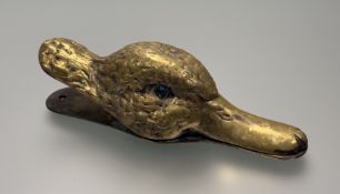 A gilt-metal duck's head desk paper clip, modelled with blue glass eyes and with spring action.