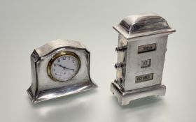 A Silver cased desk Top Clock and Calander, desk top clock with inset enamelled white face (hall-