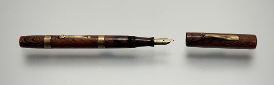 A 1927 Waterman's Ideal no.52 red ripple fountain pen with 9k gold bands, some colour fading,