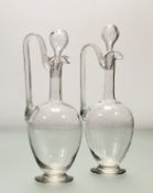 A near pair of glass wine ewer decanters, poth with stoppers. (h-32cm) (2)