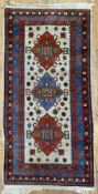 A hand-knotted Turkish/ Caucasian Kazak carpet, central panel with three medallions surrounded by