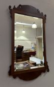 A Georgian mahogany mirror with reeded frame and scrolling fretwork (h. 89cm x w. 51.5cm) (a/f to