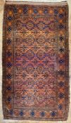 An antique hand-knotted Baluch rug, central panel with repeating geometric guls enclosed within a