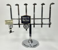 A chome-plated countertop bar optic stand, with six bottle holders, including 'Gordon's Gin' and '