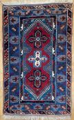 An antique hand-knotted Turkish Kazak rug, central panel with three medallions with bold geometric