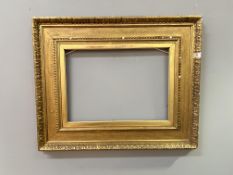 A late 19th/early 20thc gilt composition frame with beaded inner moulding and a foliate outer border