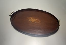 A large oval mahogany drinks tray with inlaid satinwood decoration to centre and twin brass