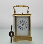 An Edwardian French brass four glass repeater table clock with cream enamel and floral decorated