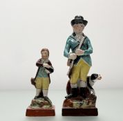 An early 19thc earthenware standing figure of a Gamekeeper with Spaniel on a naturalistic and square