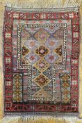An antique Baluchi prayer rug, central panel with all-over diamond repeating motifs enclosed