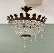 A Rococo Style gilt metal motif light fitting with cut gem stylisted glass drops. (w-36cm h-38cm)