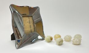 A collection of six polished onyx stone eggs (l. 8cm), together with a large frame with shaped and
