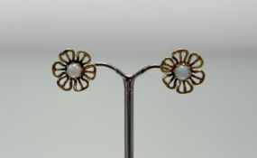 A pair of 9ct gold open work floral design stud earrings set circular water opal cabochons: d. x 1.