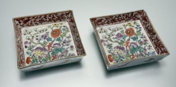 A pair of late 19thc Chinese square dishes with enamelled Blossoming Flower Garden scene to centre