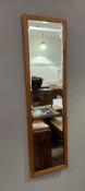 A 1970s Clark Eaton teak-framed mirror with a bevelled mirror plate (h. 125cm x w. 35cm)