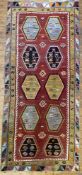 A hand-knotted flat-woven Turkish kilim rug, central panel with ten hexagonal medallions