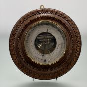 An Edwardian Paris France carved oak circualr wall, Holosteric barometer with silverd dial and