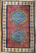 An antique Turkish Oushak carpet, central panel with twin diamond medallions with stepped edges,