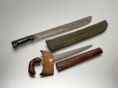 A Malaysian kris, with turned wooden grip, and watered steel blade, in a wooden scabbard; together