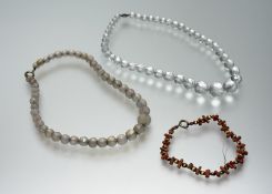 An Edwardian faceted and round cut natural opaque quartz bead necklace with ring fastening: l. x