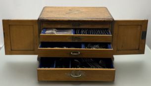 An Edwardian oak table canteen fitted recessed brass carry handles to the side and twin panel