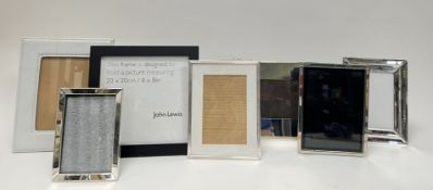 A collection of contemporary photo frames comprising; an example with bevelled mirrored frame, a