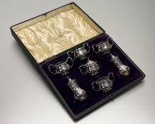 A George V Walker & Hall Sheffield silver seven-piece baluster form condiment set: pepperette h. x