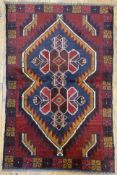 A modern hand-knotted Baluchi rug, central medallion with pointed arches featuring stylized flower