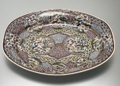 A Portuguese highly decorative hand-painted ceramic platter, marked verso, crack verso. (l-57.5cm