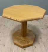 A mid-century solid oak occasional table, octagonal top with rounded edges raised on a column with