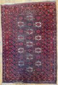 An antique Turkmen Tekke rug, central panel with three rows of repeating geometric guls enclosed