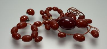 A vintage 1920s stand and loose of mid butterscotch graduated amber beads: largest: l. x 3.5cm 60.2g