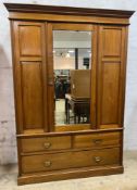 An Edwardian mahogany two-part wardrobe, moulded cornice to top over three-panel front, central