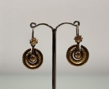 A pair of late 19thc yellow metal circular pendant earrings with chased and crimped border suspended