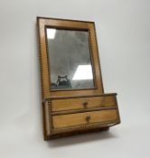 An Arts and Crafts pine bathroom cabinet with carved beaded border, featuring a mirror plate to