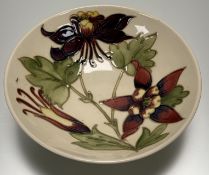 A Moorcroft Pottery Columbine pattern dipped bowl, marked verso. (w-18cm)