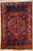 A hand-knotted Persian Hamadan rug, central hexagonal medallion with stylized flowerheads and