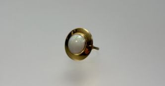 A 9ct gold ring of broad circualr design set water opal cabochon: d. 1cm G/H 4.28g