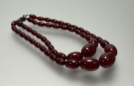 A vintage dark treacle graduated two-stand amber bead necklace with modern clasp fastening: