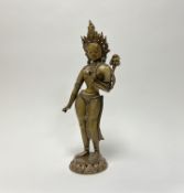 A cast brass figure of Hindu Goddess of Parvati on a circular pierced base (h. 45cm)