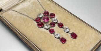 A stunning Edwardian white metal necklace with a ring of red and clear circualr faceted cut paste