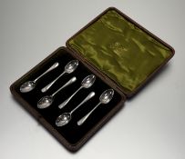 An Edwardian Sheffield silver set of six coffee spoons in moss green velvet and satin-lined box